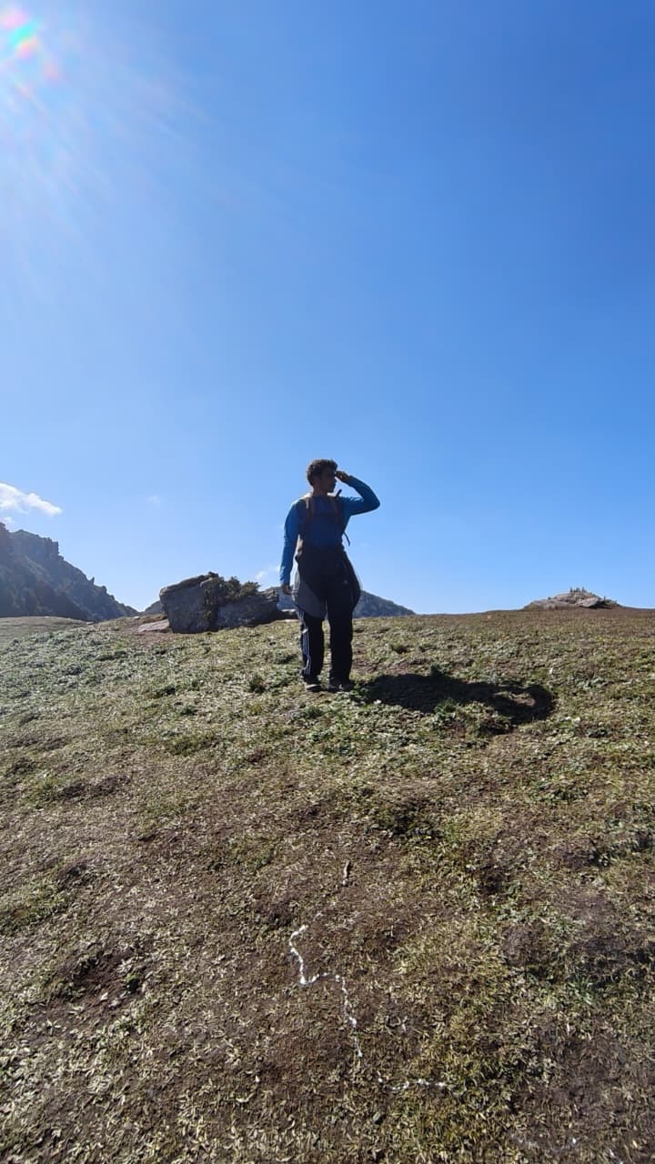 Dev on a ridge beneath a clear blue sky