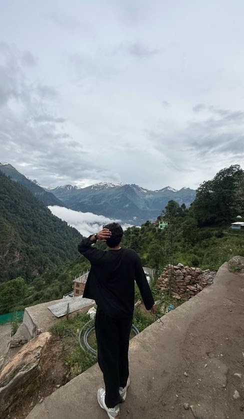 Dev walking toward a cloud-covered valley